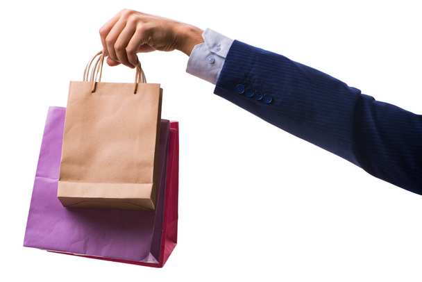 Hand holding shopping bags with christmas shopping on white back - Foto, imagen