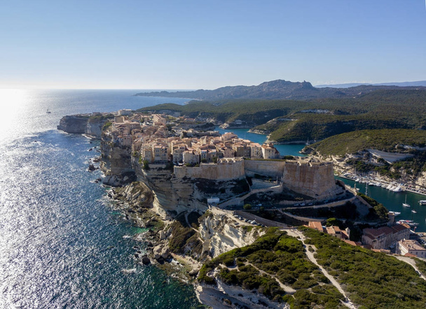 Aerial view of Bonifacio old town built on cliffs of white limestone, cliffs. Harbor. Corsica, France - 写真・画像