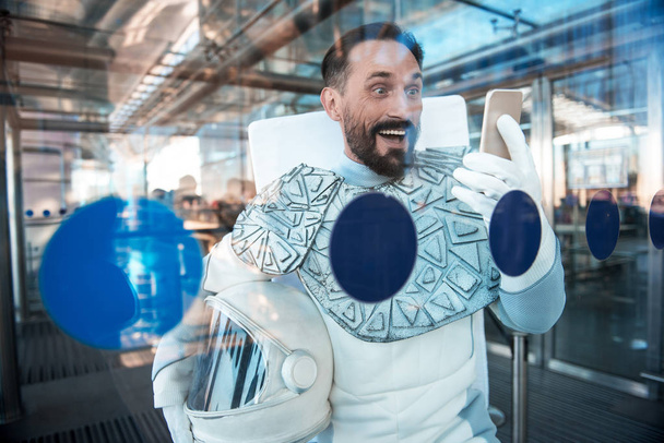 Merry amazed man in armor for space - Foto, Bild