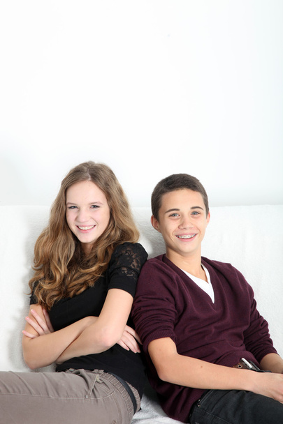 Happy teenage couple sitting together - Zdjęcie, obraz