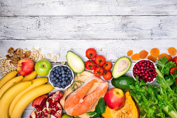 Background of healthy food for heart. Healthy food, diet and healthy life concept. Fresh fish, fruits, vegetables, berries and nuts. Top view - Photo, Image