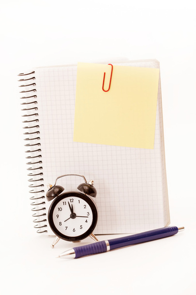 Alarm clock, blank notebook sheet on the white - Zdjęcie, obraz
