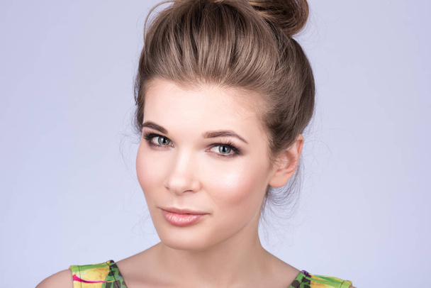 Horizontal portrait of a beautiful young woman with beautiful hairstyle - Фото, изображение