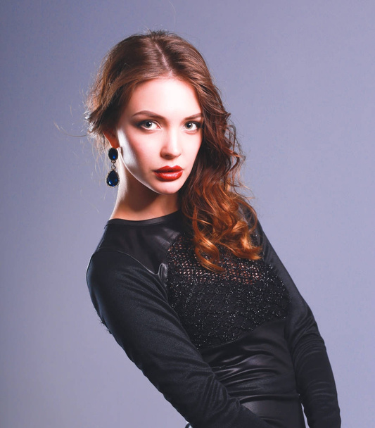 Beautiful woman with evening make-up in black dress - Foto, Imagen