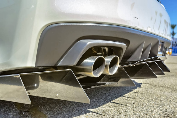 Close up of a dual exhaust pipe on a white car with tail spikes - Photo, Image