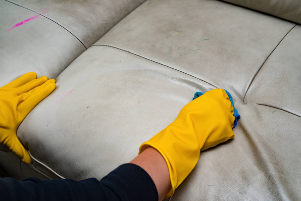 cleaning leather sofa at home with wet towel - Photo, Image