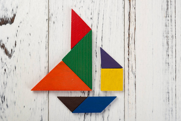 wooden tangram in a sailboat shape - Foto, imagen