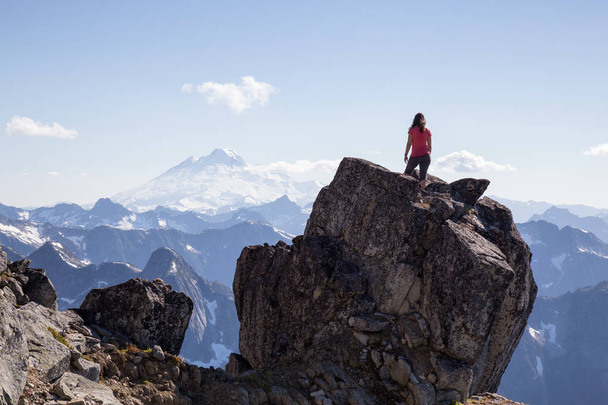 Female hiker enjoying the beautiful view on top of Macdonald Peak near Chilliwack, East of Vancouver, British Columbia, Canada. Taken on a bright sunny summer day. - Fotografie, Obrázek