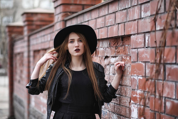 Молодая красивая девушка в шляпе и с темным макияжем снаружи. G
 - Фото, изображение