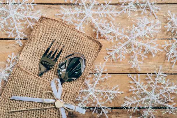 christmas table place setting and silverware, snowflakes on wood - Photo, Image