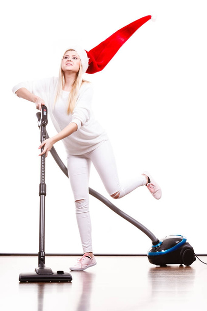 Girl in santa helper hat with vacuum cleaner - Фото, изображение