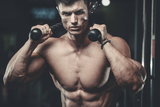 Attractive model young man training in gym - Фото, зображення