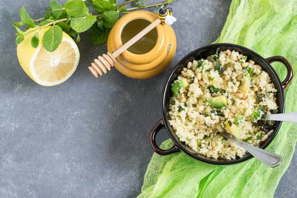 Bowl with couscous, avocado, mint and nuts  - Photo, Image