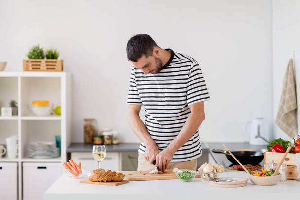 man cooking food at home kitchen - Фото, зображення