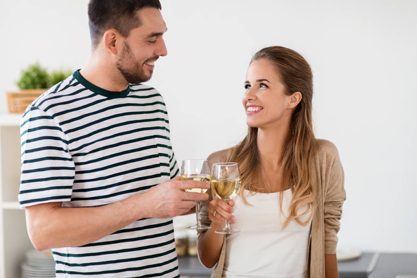 happy couple drinking wine at home - 写真・画像