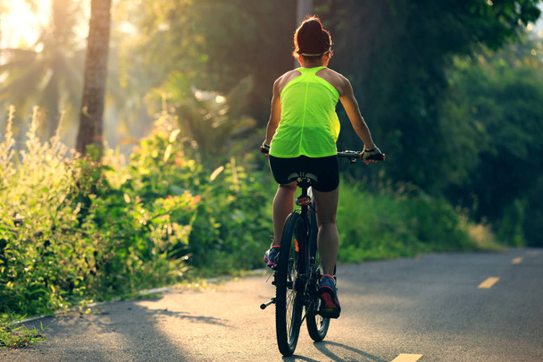 woman cycling on forest trail - Photo, image