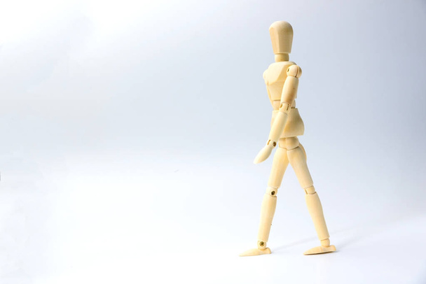 Wooden figure doll with walking action for business concept on w - Photo, image