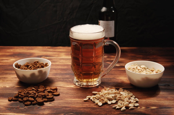 Beer light in a mug and snack - Photo, Image