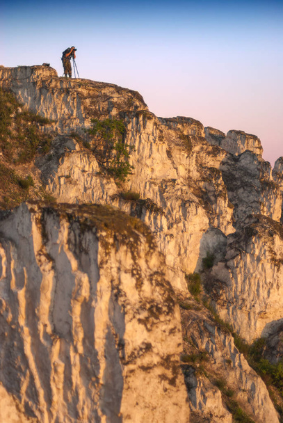 Photographer on a cliff with a camera - Φωτογραφία, εικόνα