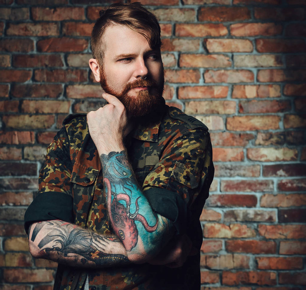 Портрет рудого бородатого чоловіка з татуюваннями
 - Фото, зображення