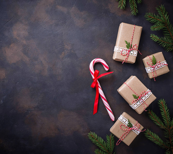 Christmas gift boxes and candy cane. - Фото, изображение