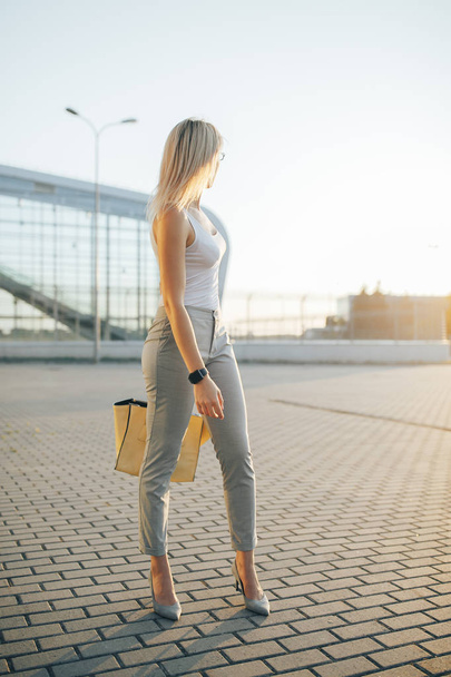 Business woman wearing sunglasses in gray pants - Photo, Image