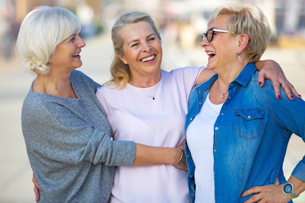 Group of smiling senior women standing outside - Foto, imagen