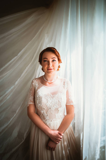 Portrait of a beautiful young bride near the window - Fotoğraf, Görsel