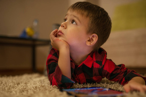 Boy is playing games on his tablet computer - Photo, Image