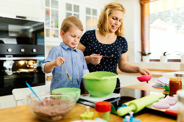 Child helping mother make cookies - Photo, Image