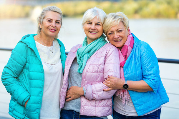Group of smiling senior women standing outside - Photo, image