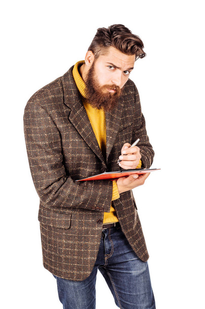 portrait of bearded businessman with a pen and schedule book or diary in hand. human emotion expression and office, business, finances concept. image isolated white background. - Foto, Bild