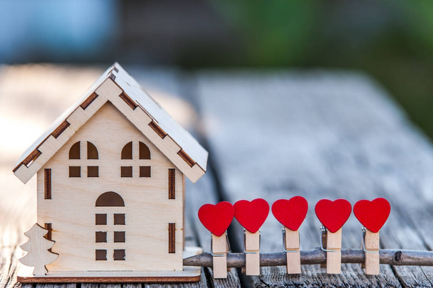 A toy house with a fence of hearts.  - Photo, Image