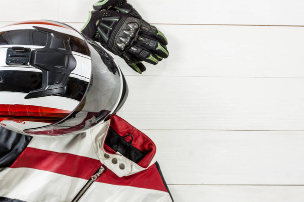 View of motorcycle rider accessories placed on white wooden tabl - 写真・画像