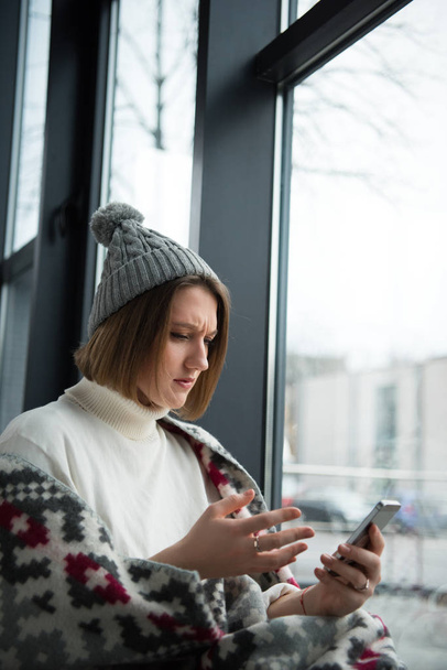 Stressed woman looking at smartphone - Photo, image