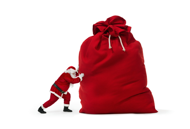 Santa Claus πιέζει τεράστια σακούλα δώρου - Φωτογραφία, εικόνα