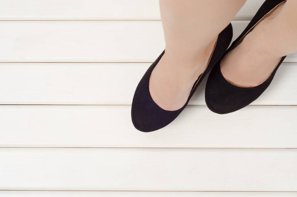 Female feet with black shoes - Фото, изображение