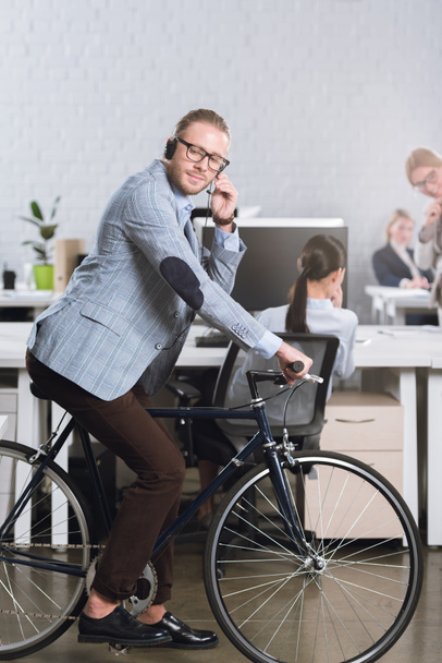 call center operator in headset on bicycle - Photo, image