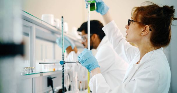 Young students of chemistry working in laboratory - Φωτογραφία, εικόνα
