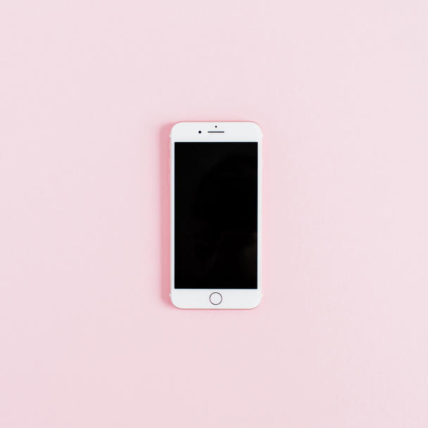 Blank screen smartphone isolated on pink background. Flat lay mock up with copy space. - Fotó, kép