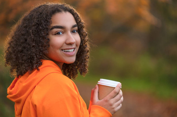 Mixed Race Female Teenager Woman Drinking Coffee in Fall Autumn - Foto, imagen