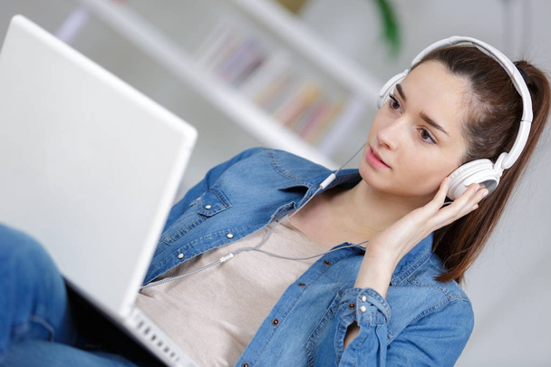 young woman with headphones and laptop - Photo, image