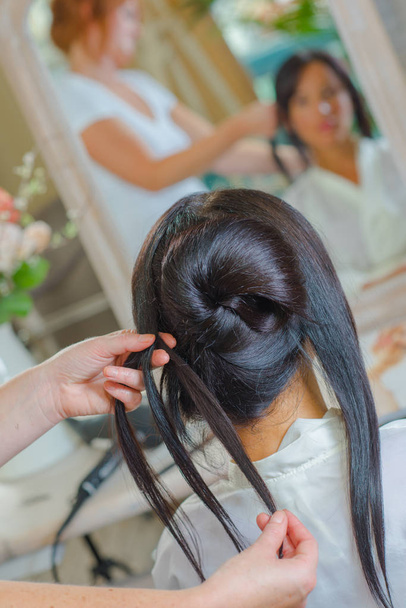 Woman having hair styled by hairdresser - Photo, image