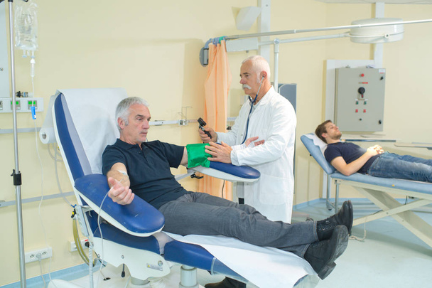 Man having blood pressure tested in hospital - Fotoğraf, Görsel