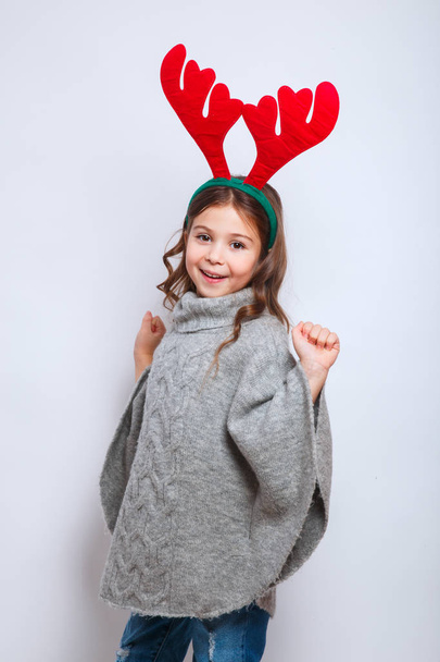 merry christmas and happy new year .Smiling funny child in deer horns on white background - Fotoğraf, Görsel