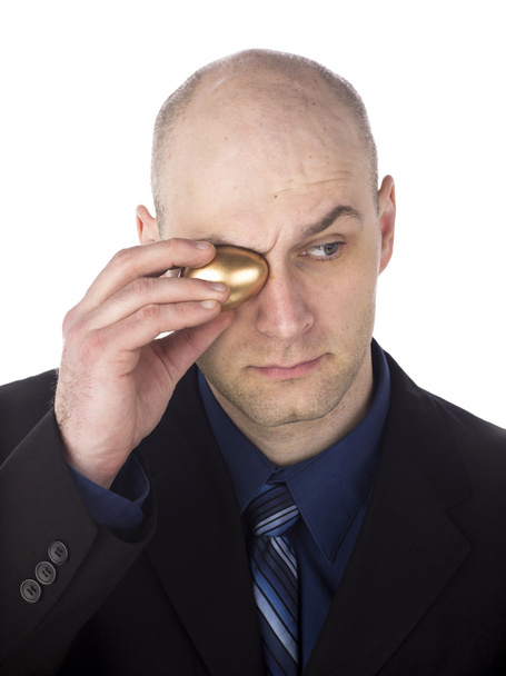 man covering eyes with golden egg - Photo, Image