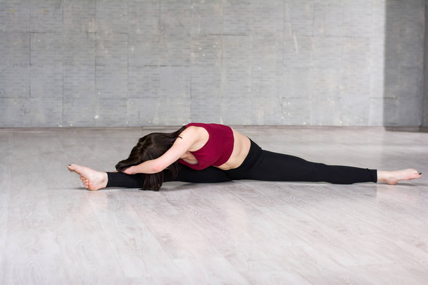 Slim woman stretching in studio. - Foto, imagen