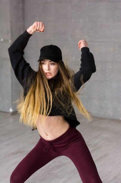Pretty slim modern style dancer in movement. - Photo, image