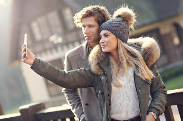 Happy couple walking outdoors in winter - Fotografie, Obrázek