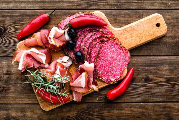 Cold meat platter with salami, slices ham prosciutto, italian antipasti on wooden board - Foto, immagini